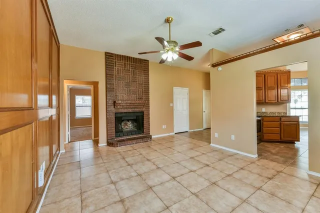 a view of a livingroom with a fireplace a chandelier and stairs