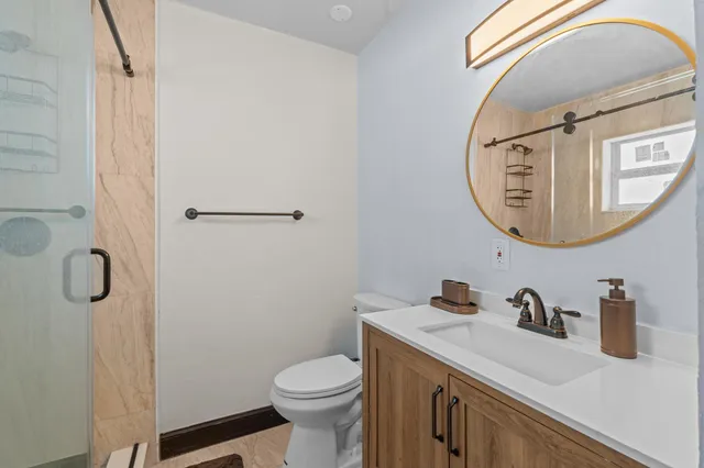 a bathroom with a toilet and a shower