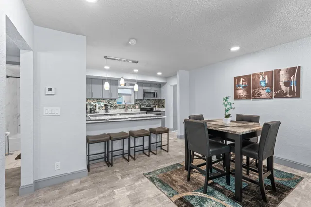 a kitchen with a stove a sink and a refrigerator