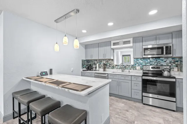 a kitchen that has a lot of cabinets in it