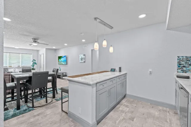 a kitchen with stainless steel appliances granite countertop a stove microwave and sink