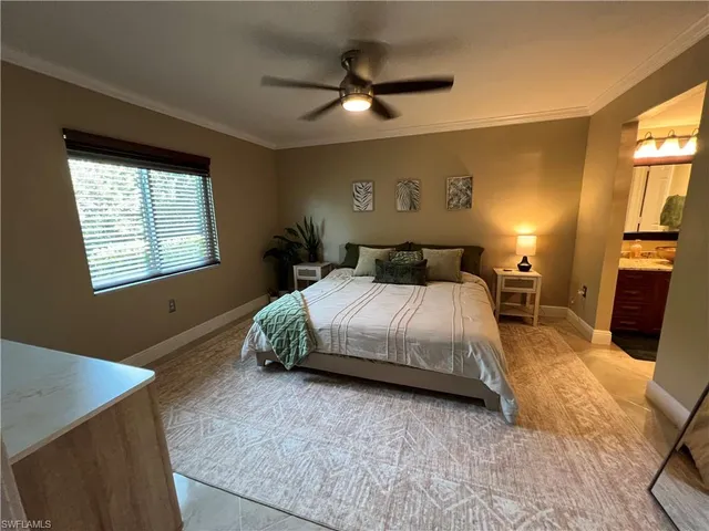 a spacious bedroom with a bed and a chandelier