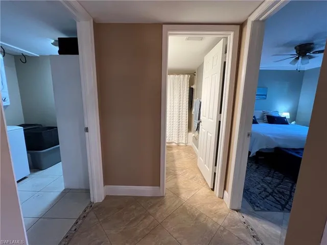 a view of a hallway and a livingroom with furniture