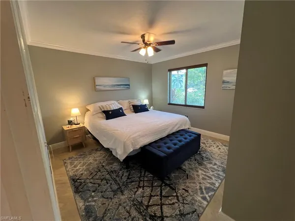 a bedroom with a bed and window
