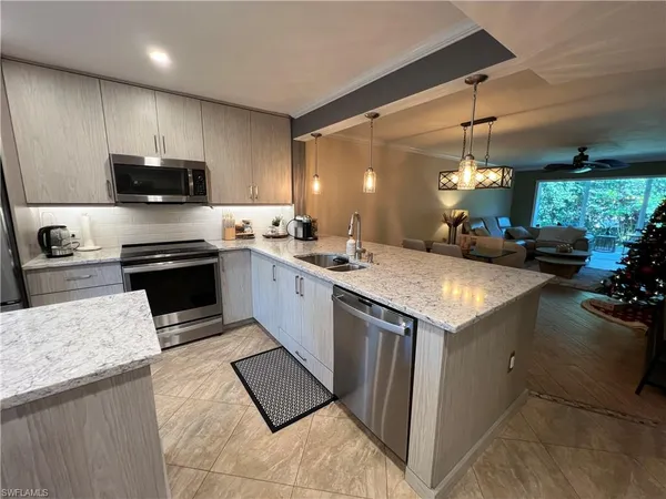 a kitchen with a sink stove and microwave