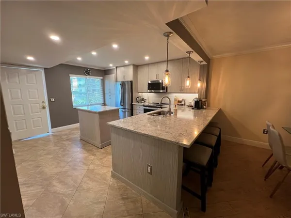 a kitchen with a table and chairs in it