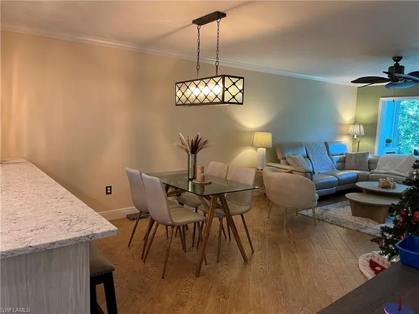 a view of a dining room with furniture wooden floor and chandelier