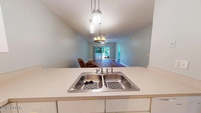 a kitchen with a stove a sink and a refrigerator
