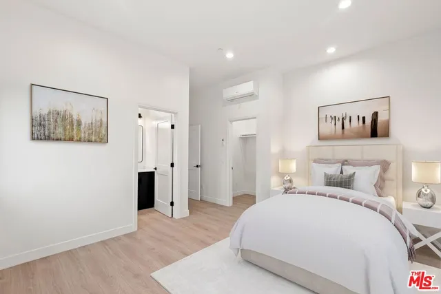 a bedroom with a bed and a painting on the wall