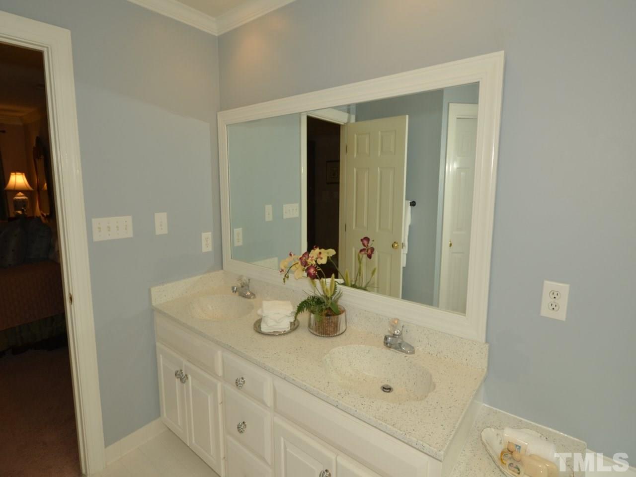 716 Presnell Court Raleigh, NC 27615 - Photo 14 of 25 a bathroom with a sink and a mirror