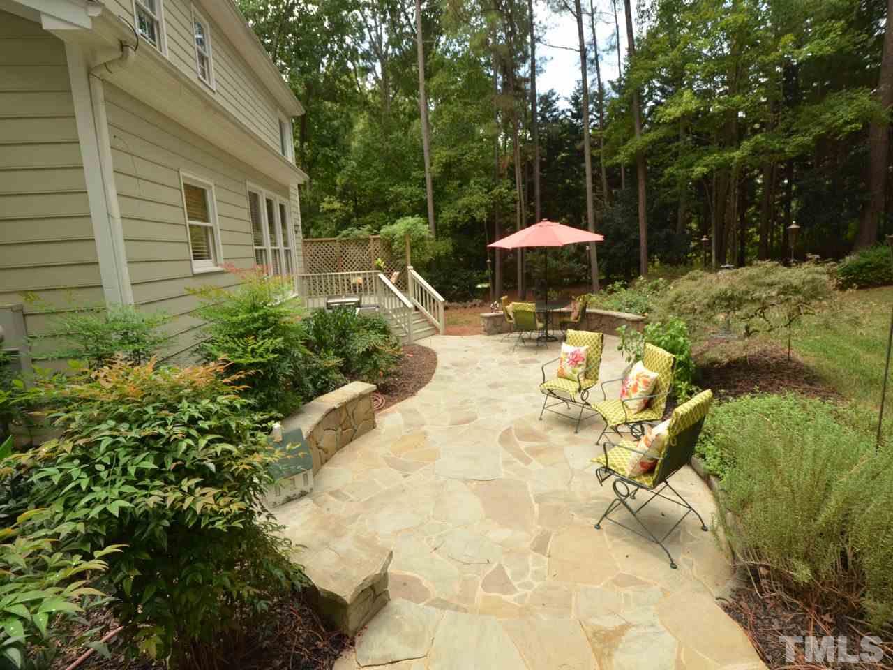 716 Presnell Court Raleigh, NC 27615 - Photo 22 of 25 a view of a backyard with furniture and a garden