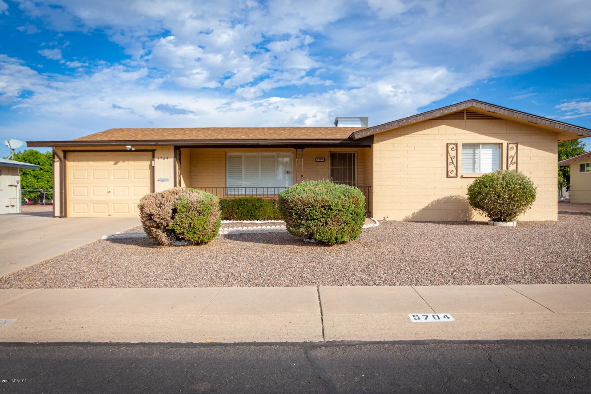 5704 East Decatur Street Mesa, AZ 85205 - Photo 2 of 40 a front view of a house with garden