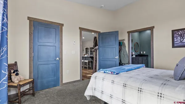 a bedroom with a bed and a chandelier