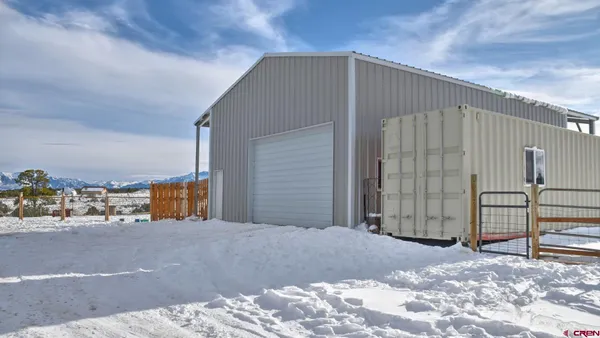 a work room with furniture and a potted plant