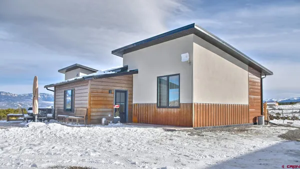 a view of a house with a snow in the yard