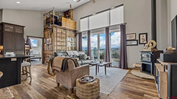 a living room with furniture and a floor to ceiling window