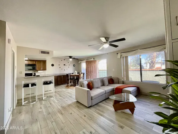 a living room with furniture fireplace and window