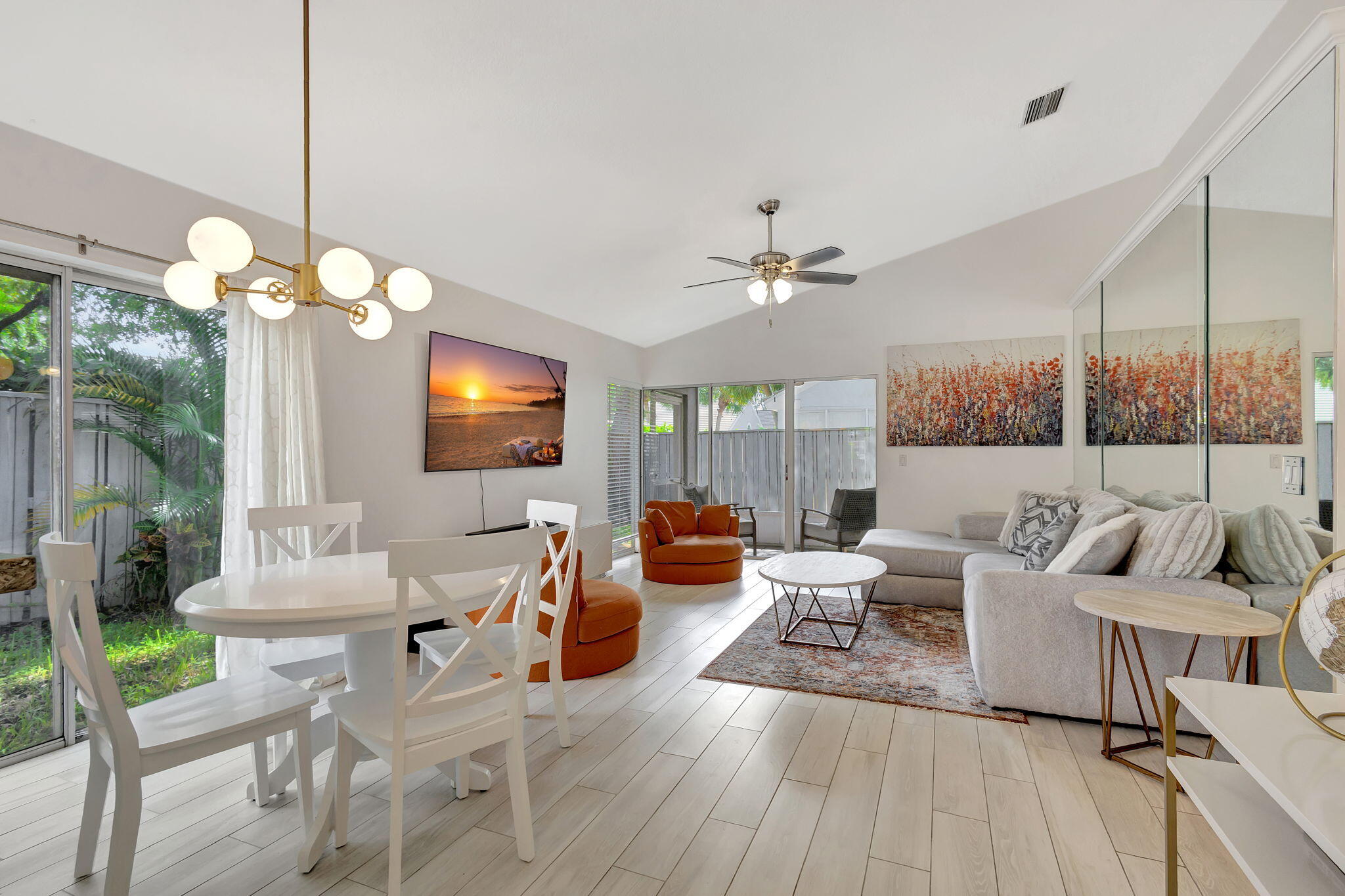 15 Admirals Court Palm Beach Gardens, FL 33418 - Photo 12 of 29 a living room with furniture a chandelier and a flat screen tv