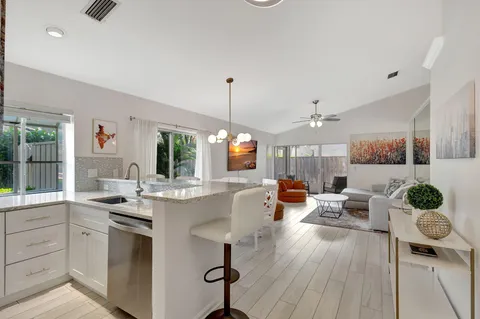 a kitchen with stainless steel appliances granite countertop a stove and cabinets