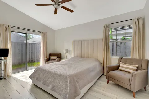 a bedroom with a bed couch and window