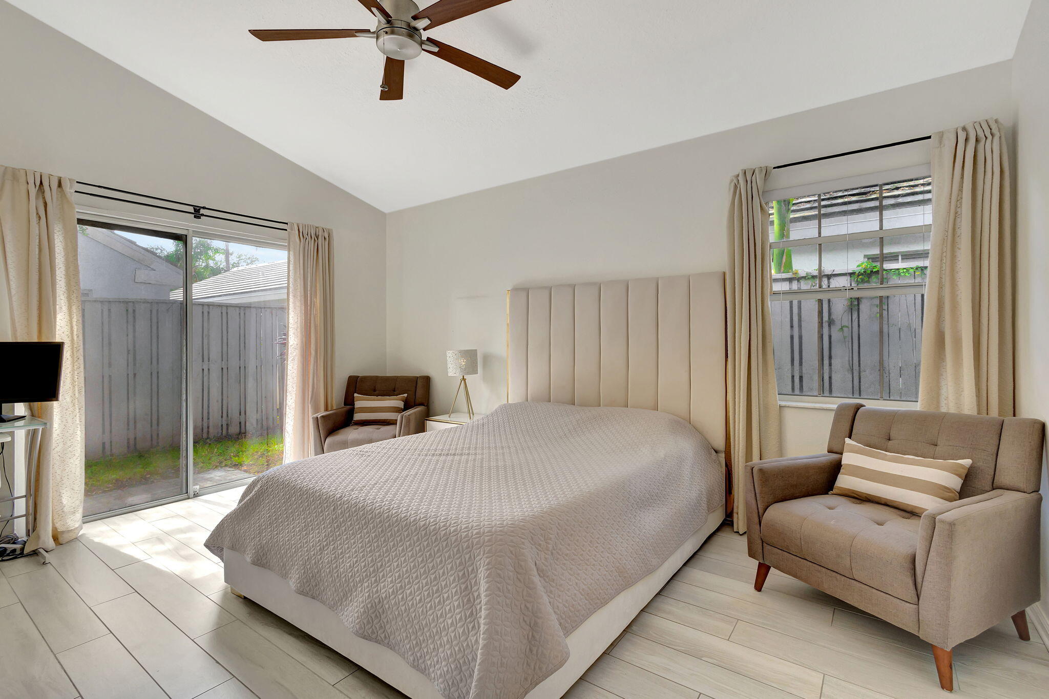 15 Admirals Court Palm Beach Gardens, FL 33418 - Photo 17 of 29 a bedroom with a bed couch and window