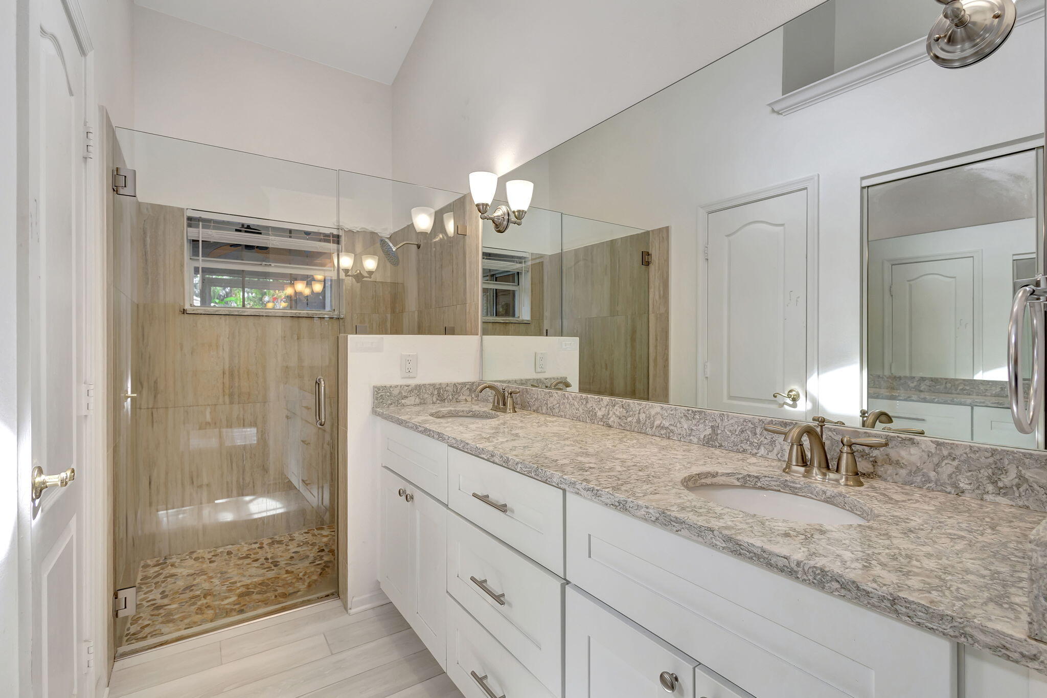 15 Admirals Court Palm Beach Gardens, FL 33418 - Photo 18 of 29 a bathroom with a granite countertop sink a mirror and shower