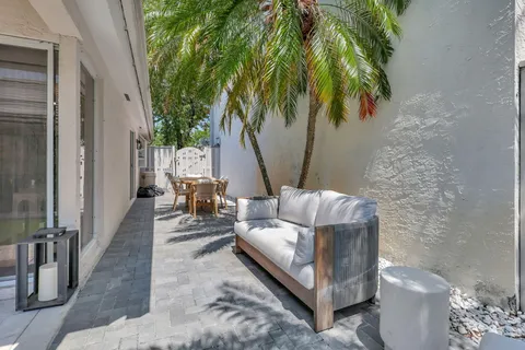 a view of a patio with couches and a potted plant