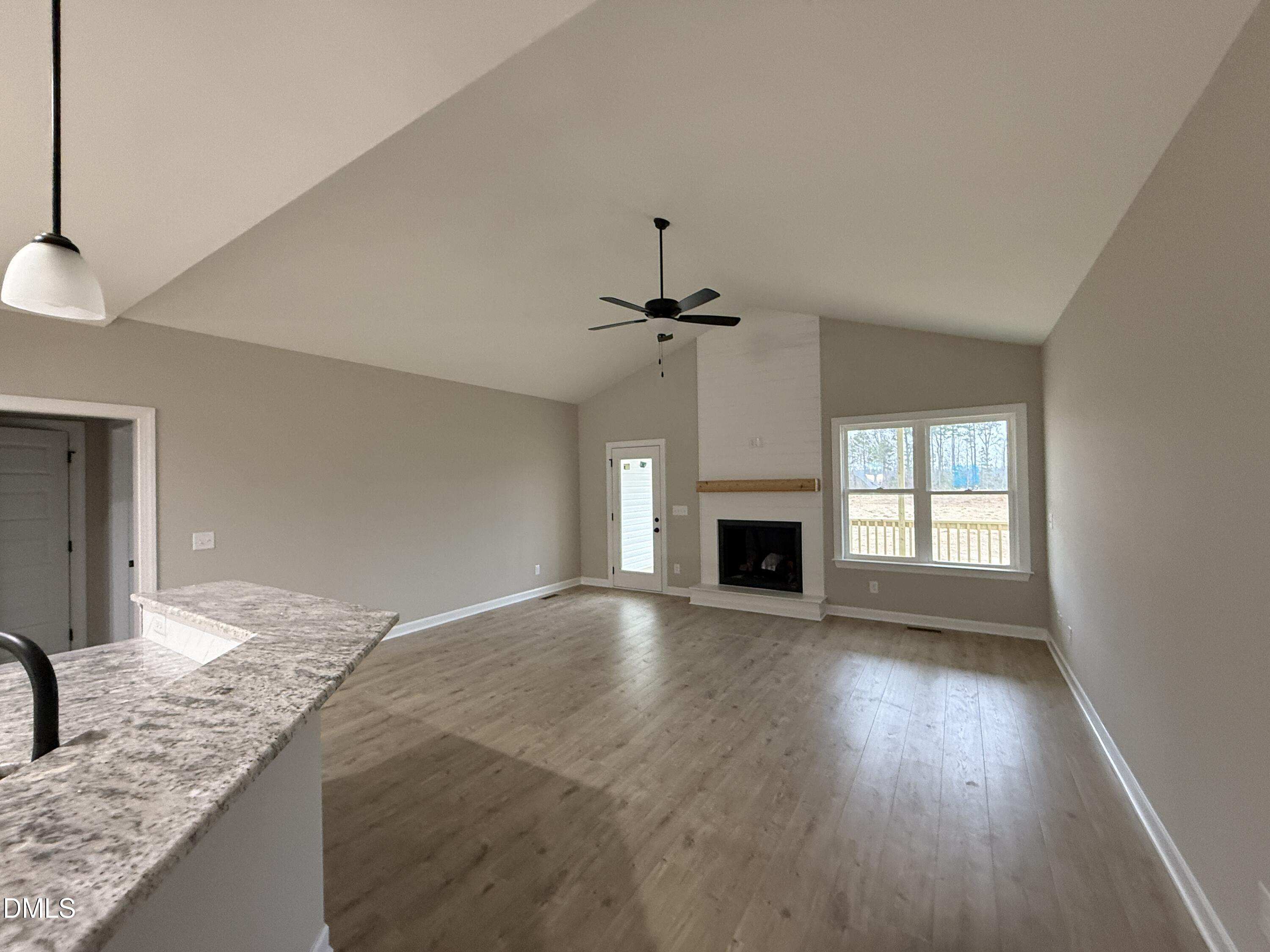 181 Royal Avenue Selma, NC 27576 - Photo 3 of 10 a view of an empty room with a fireplace and a window