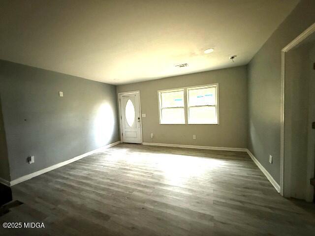 1664 Randall Road Macon, GA 31206 - Photo 3 of 9 an empty room with wooden floor and windows