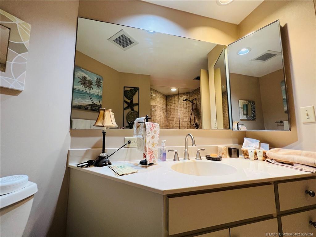 221 Northeast Plantation Road, Unit 215 Stuart, FL 34996 - Photo 60 of 83 a bathroom with a sink and a mirror