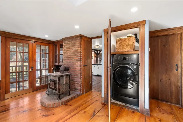 a living room with furniture a flat screen tv and floor to ceiling window