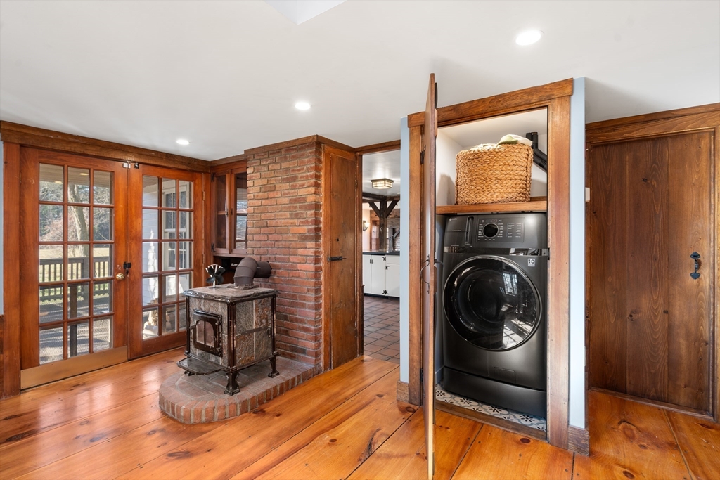 220 South Main Street Sherborn, MA 01770 - Photo 13 of 40 a living room with furniture a flat screen tv and floor to ceiling window