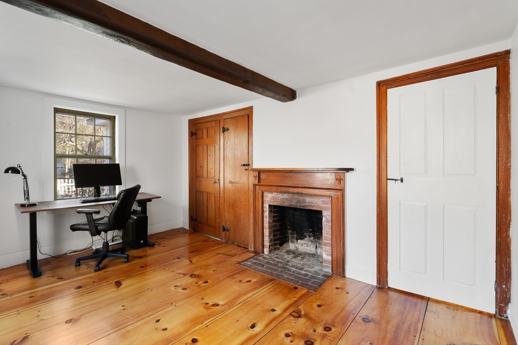 220 South Main Street Sherborn, MA 01770 - Photo 14 of 40 a workspace with wooden floor a fireplace and windows