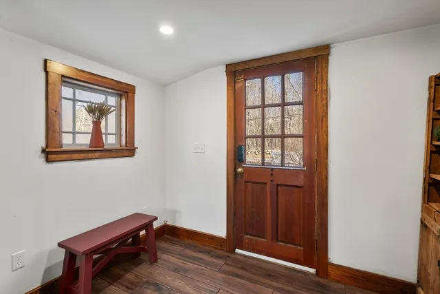 a room that has a dresser and wooden floor