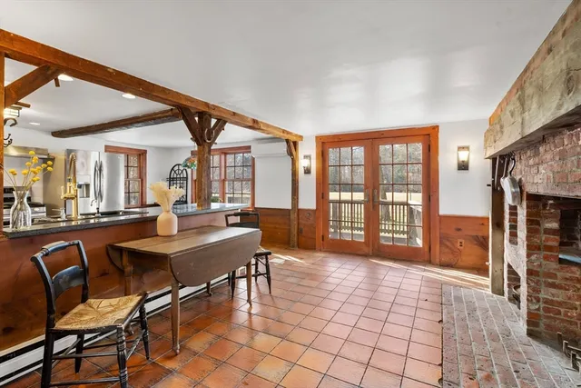 a dining room with furniture a chandelier and wooden floor