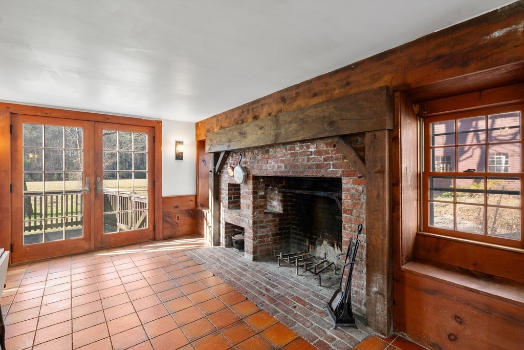 220 South Main Street Sherborn, MA 01770 - Photo 6 of 40 a view of an empty room with a fireplace and a window