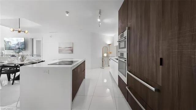 a kitchen with a sink and refrigerator
