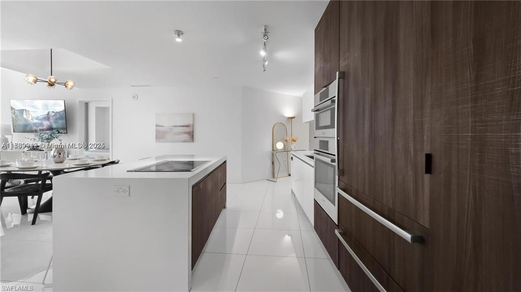 851 Northeast 1st Avenue, Unit 3303 Miami, FL 33132 - Photo 16 of 46 a kitchen with a sink and refrigerator