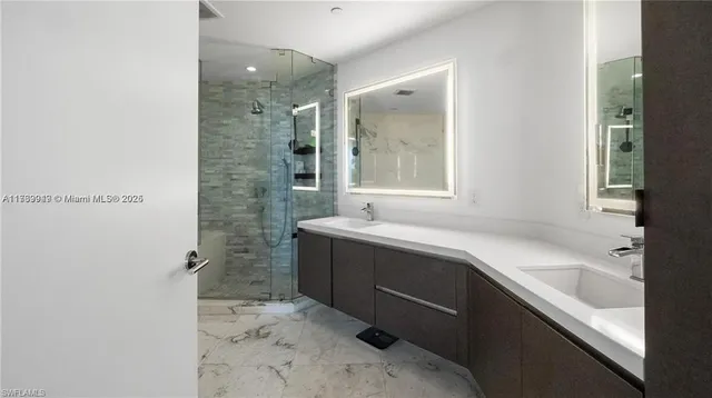 a bathroom with a bathtub sink and mirror