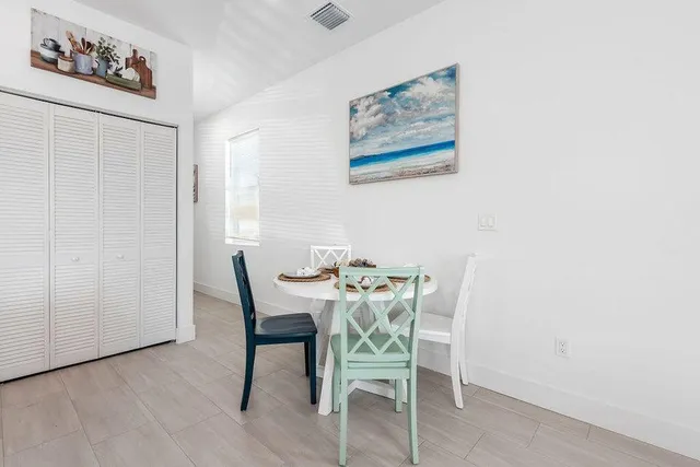 a dining room with furniture and wooden floor