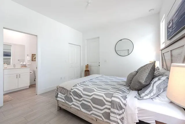 a bedroom with a bed and cabinets