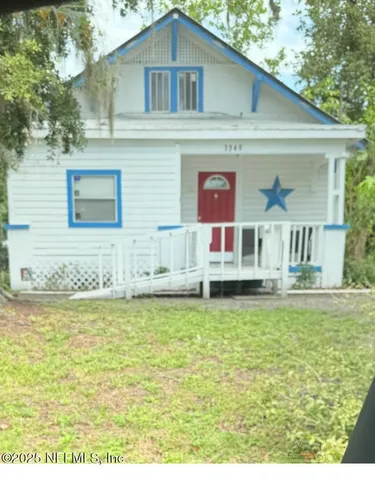a front view of a house with a garden