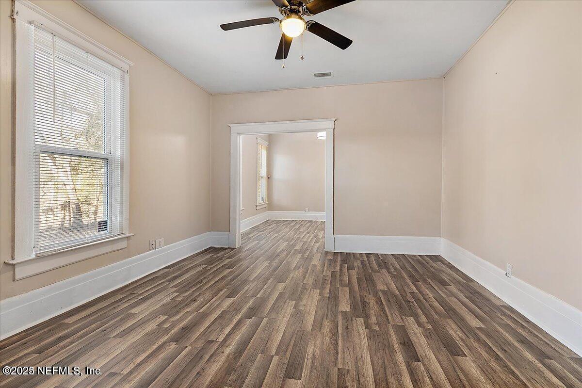5349 Rio Grande Avenue Jacksonville, FL 32254 - Photo 3 of 6 wooden floor in an empty room with a window