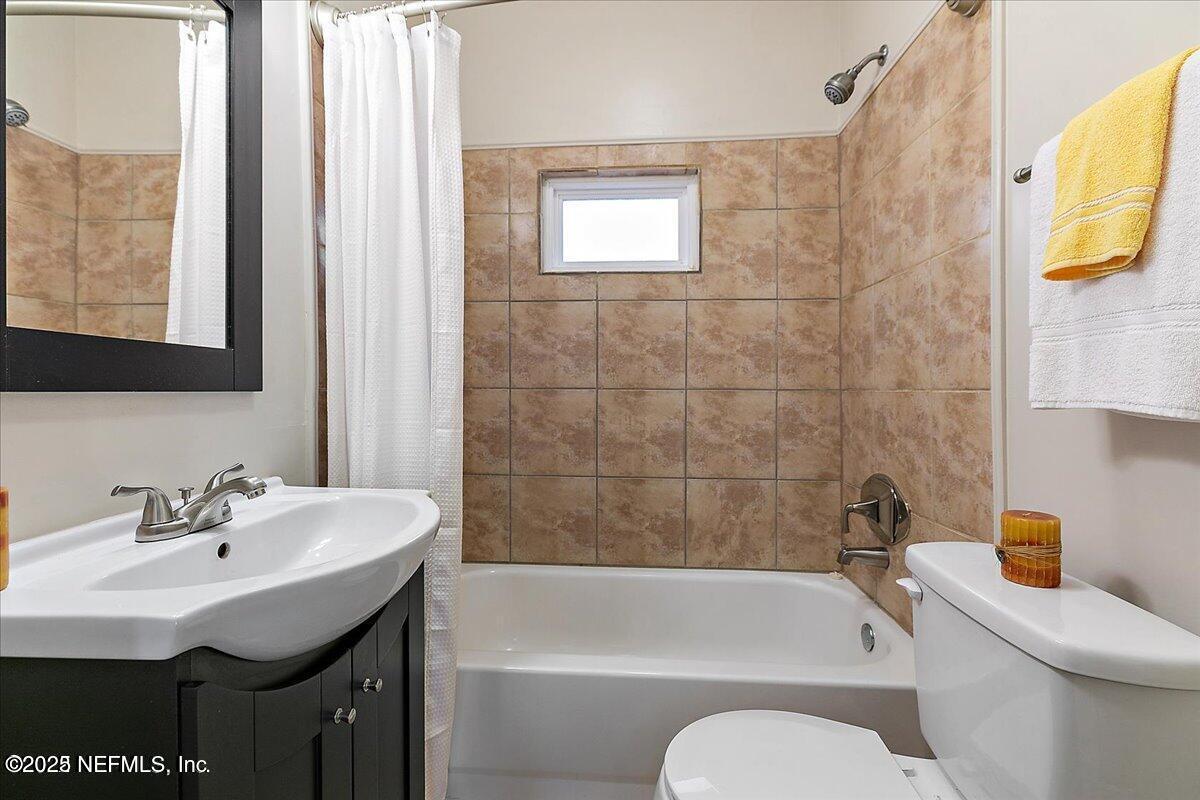 5349 Rio Grande Avenue Jacksonville, FL 32254 - Photo 4 of 6 a bathroom with a sink a toilet and bathtub