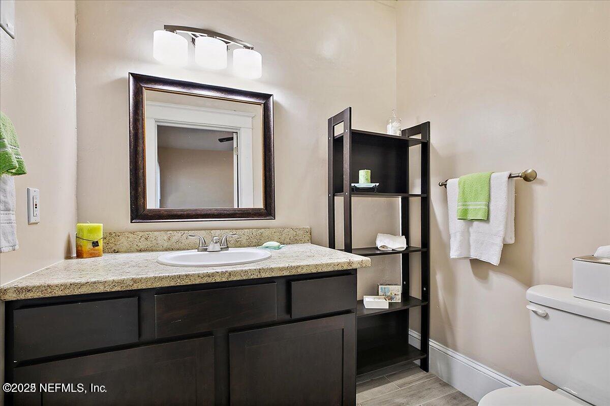 5349 Rio Grande Avenue Jacksonville, FL 32254 - Photo 5 of 6 a bathroom with a sink and a mirror