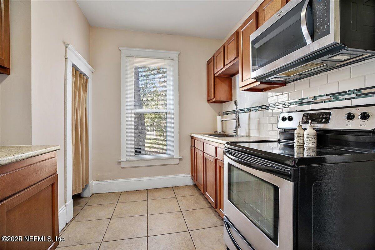 5349 Rio Grande Avenue Jacksonville, FL 32254 - Photo 6 of 6 a kitchen with a stove cabinets and a window
