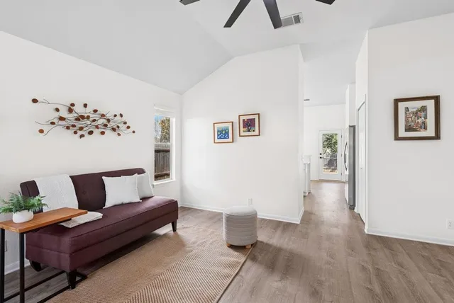 a living room with furniture and wooden floor