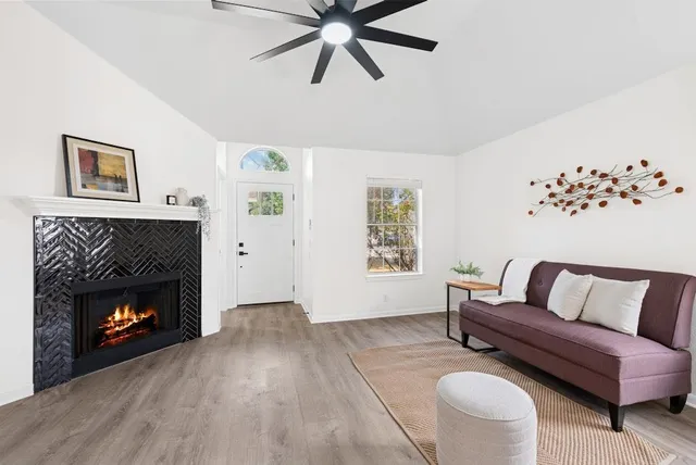 a living room with furniture and a fireplace
