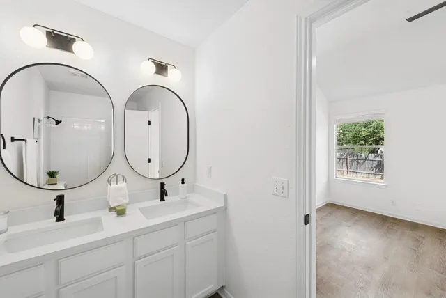 a bathroom with 2 sink and a mirror