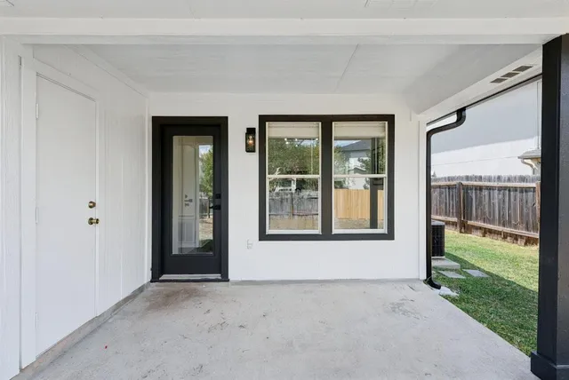 a view of a big room with a large window and front door